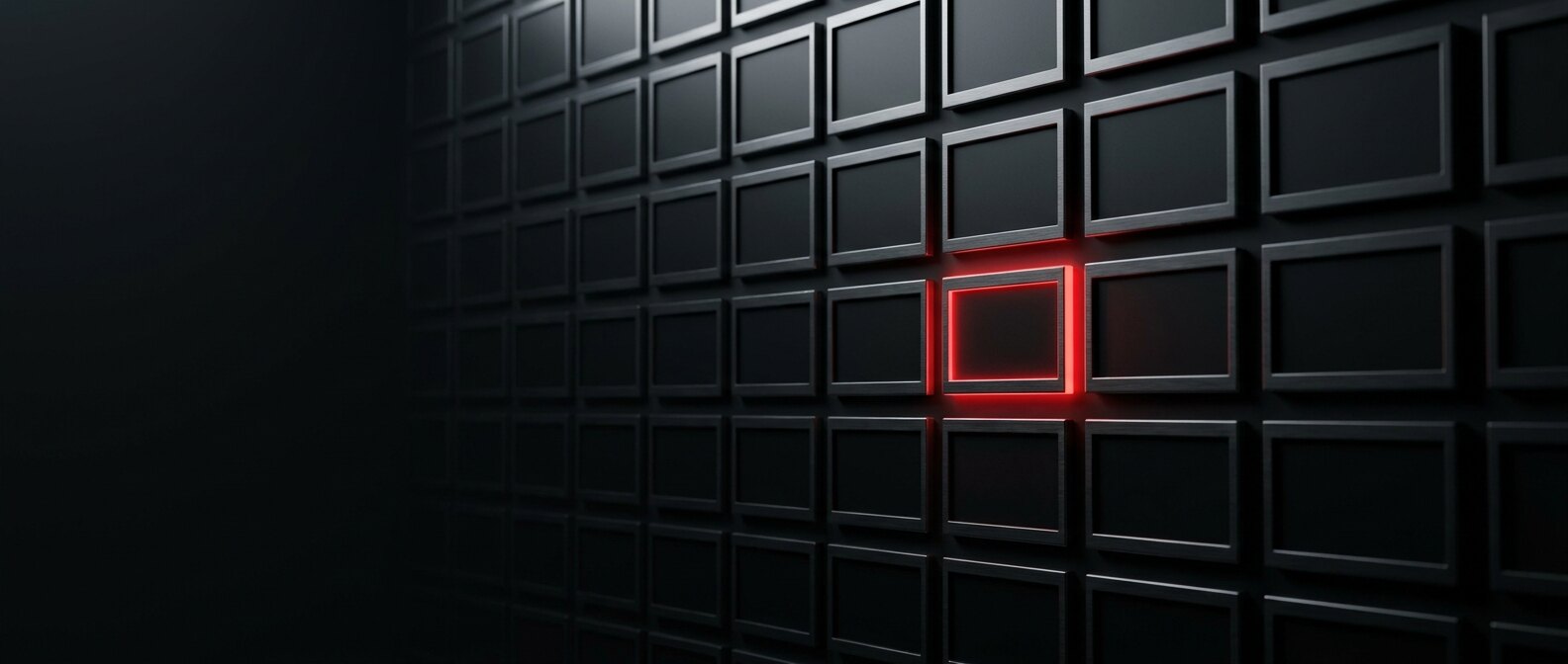 Wall of identical blank matte-black nameplates with a single one rim-lit in red